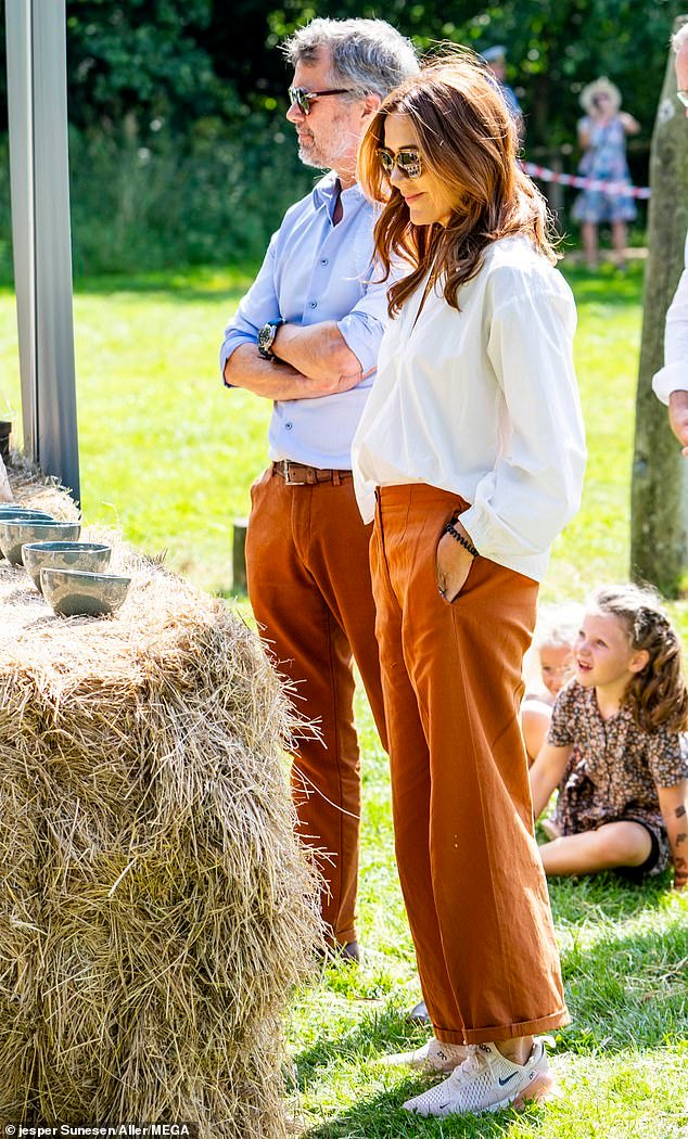 Queen Mary, 52, looked stylish and effortless in a white shirt, rust-coloured trousers and chunky trainers.