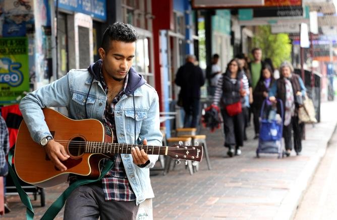 Busker Reuben De Melo plays for Oxford St Leederville in 2014.